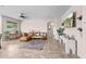 Bright living room with large windows, a ceiling fan, and stylish decor accents at 517 S 165Th Dr, Goodyear, AZ 85338
