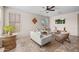 Comfortable living room with natural light, wicker furniture, ceiling fan, and tile flooring at 517 S 165Th Dr, Goodyear, AZ 85338