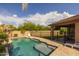 Inviting backyard pool and patio with a covered area, perfect for outdoor relaxation and entertainment at 517 S 165Th Dr, Goodyear, AZ 85338