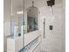 Contemporary shower with sleek tile, a glass enclosure, and a rain shower head at 517 S 165Th Dr, Goodyear, AZ 85338