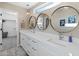 Modern bathroom with dual sinks, quartz countertop, three decorative round mirrors, and pendant lighting at 6220 E Paradise Ln, Scottsdale, AZ 85254
