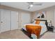 This bedroom boasts carpet floors, a ceiling fan, a large closet, and bright natural light at 6220 E Paradise Ln, Scottsdale, AZ 85254