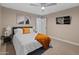 Comfortable bedroom features neutral tones, ceiling fan, and zebra artwork above the headboard at 6220 E Paradise Ln, Scottsdale, AZ 85254