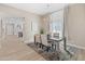Elegant dining area with a stylish chandelier, modern table setting, and an open view to the kitchen at 6220 E Paradise Ln, Scottsdale, AZ 85254