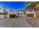 Stunning single-story home featuring a well-manicured front yard, desert landscaping, and a circular driveway at 6220 E Paradise Ln, Scottsdale, AZ 85254