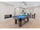 Entertaining game room complete with pool table, fireplace, and backyard access at 6220 E Paradise Ln, Scottsdale, AZ 85254