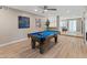 Spacious game room with pool table, fireplace, and backyard access, perfect for entertaining at 6220 E Paradise Ln, Scottsdale, AZ 85254