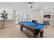 Bright game room features a pool table, fireplace, and open access to the kitchen and Gathering room at 6220 E Paradise Ln, Scottsdale, AZ 85254