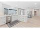Bright, all-white kitchen, featuring stainless steel appliances, a kitchen island, and light wood flooring at 6220 E Paradise Ln, Scottsdale, AZ 85254