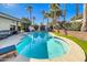 Beautiful backyard featuring a sparkling pool, lush landscaping, string lights, and a covered patio at 6220 E Paradise Ln, Scottsdale, AZ 85254