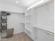 Walk-in closet with built-in shelving and storage solutions offers ample space for organization at 6220 E Paradise Ln, Scottsdale, AZ 85254