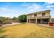 A spacious backyard featuring a sparkling pool, lush green landscaping, and a patio area for relaxation and entertainment at 6245 W Maya Dr, Phoenix, AZ 85083