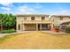 A spacious backyard featuring a covered patio, an outdoor kitchen area, and a well-maintained lawn for outdoor enjoyment at 6245 W Maya Dr, Phoenix, AZ 85083