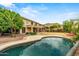Inviting backyard with a large pool, lush greenery, and a covered patio perfect for outdoor entertaining at 6245 W Maya Dr, Phoenix, AZ 85083