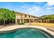 Expansive backyard showcasing a beautiful pool, lush lawn, and covered patio, perfect for outdoor living and entertaining at 6245 W Maya Dr, Phoenix, AZ 85083