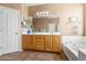 Spacious bathroom showcasing double sink vanity, soaking tub, and separate water closet at 6245 W Maya Dr, Phoenix, AZ 85083