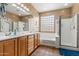 Well-lit bathroom features double sinks, soaking tub, glass block window, and separate shower at 6245 W Maya Dr, Phoenix, AZ 85083