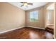 Bedroom with wood flooring, ceiling fan, view of the neighborhood, and access to stairs at 6245 W Maya Dr, Phoenix, AZ 85083