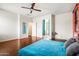 Spacious primary bedroom with wood floors and ensuite bath access offers comfort at 6245 W Maya Dr, Phoenix, AZ 85083