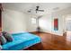 Bright bedroom boasts wood floors, a ceiling fan, and large windows at 6245 W Maya Dr, Phoenix, AZ 85083