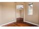 View of arched entrance to bedroom with ceiling fan, plus window with neighborhood views at 6245 W Maya Dr, Phoenix, AZ 85083