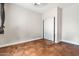 Bright, empty bedroom with neutral walls, tile flooring and a closet with sliding doors, ready for personalization at 6245 W Maya Dr, Phoenix, AZ 85083