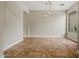 Bright dining room with travertine floors, globe pendant lights and a large window at 6245 W Maya Dr, Phoenix, AZ 85083