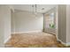 Bright dining room features travertine floors, globe pendant lights and a large window at 6245 W Maya Dr, Phoenix, AZ 85083
