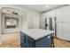 A kitchen island with white quartz countertops and blue cabinets, plus stainless steel appliances at 6245 W Maya Dr, Phoenix, AZ 85083