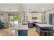 A kitchen with white and blue cabinets, a marble countertop, and stainless steel appliances at 6245 W Maya Dr, Phoenix, AZ 85083