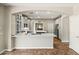 Modern kitchen features a large island, white countertops, and stainless steel appliances at 6245 W Maya Dr, Phoenix, AZ 85083
