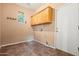 Laundry room with overhead cabinets and tiled flooring at 6245 W Maya Dr, Phoenix, AZ 85083