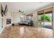 Cozy living room featuring a fireplace, travertine flooring, and sliding glass doors to the backyard at 6245 W Maya Dr, Phoenix, AZ 85083