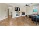 Open-concept living room showcases travertine flooring and a cozy fireplace at 6245 W Maya Dr, Phoenix, AZ 85083