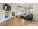 Living room with a stone fireplace, ceiling fan and windows overlooking the backyard at 6245 W Maya Dr, Phoenix, AZ 85083