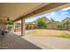 Covered patio with brick flooring overlooking a large backyard and desert mountain views at 6245 W Maya Dr, Phoenix, AZ 85083