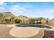 Inviting backyard pool area with tropical landscaping, a fire pit, and a serene atmosphere for relaxation and entertainment at 6245 W Maya Dr, Phoenix, AZ 85083