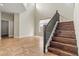 Bright living area with wood stairs and tile flooring with access to the second floor at 6245 W Maya Dr, Phoenix, AZ 85083