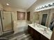 Primary bathroom with dual sink vanity, soaking tub and walk-in shower at 6920 S 46Th Dr, Laveen, AZ 85339