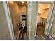 Powder room with adjacent walk-in closet featuring built-in shelving at 6920 S 46Th Dr, Laveen, AZ 85339