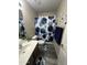 Stylish bathroom featuring blue patterned shower curtain and matching accessories at 6920 S 46Th Dr, Laveen, AZ 85339