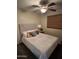 Comfortable bedroom with a ceiling fan, window and a well-made bed with stylish pillows at 6920 S 46Th Dr, Laveen, AZ 85339