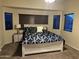 Bedroom featuring a bed with decorative pillows, a side table and multiple windows at 6920 S 46Th Dr, Laveen, AZ 85339
