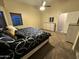 Comfortable bedroom featuring carpet floor, ceiling fan and coordinated furnishings at 6920 S 46Th Dr, Laveen, AZ 85339
