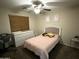 Bedroom featuring a dresser, bed with decorative pillows, and side table with decor at 6920 S 46Th Dr, Laveen, AZ 85339