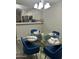Dining area with a glass table, seating for four, and modern lighting at 6920 S 46Th Dr, Laveen, AZ 85339