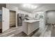 Open-concept kitchen features a central island, stainless steel appliances, and ample storage at 6920 S 46Th Dr, Laveen, AZ 85339