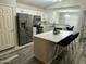 Bright kitchen featuring stainless steel appliances, island with breakfast bar, and white cabinetry at 6920 S 46Th Dr, Laveen, AZ 85339