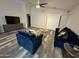 Spacious living room with a sliding glass door, modern furnishings, and a vaulted ceiling at 6920 S 46Th Dr, Laveen, AZ 85339