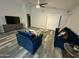 Cozy living room featuring vaulted ceiling, modern furniture, and sliding glass door access at 6920 S 46Th Dr, Laveen, AZ 85339